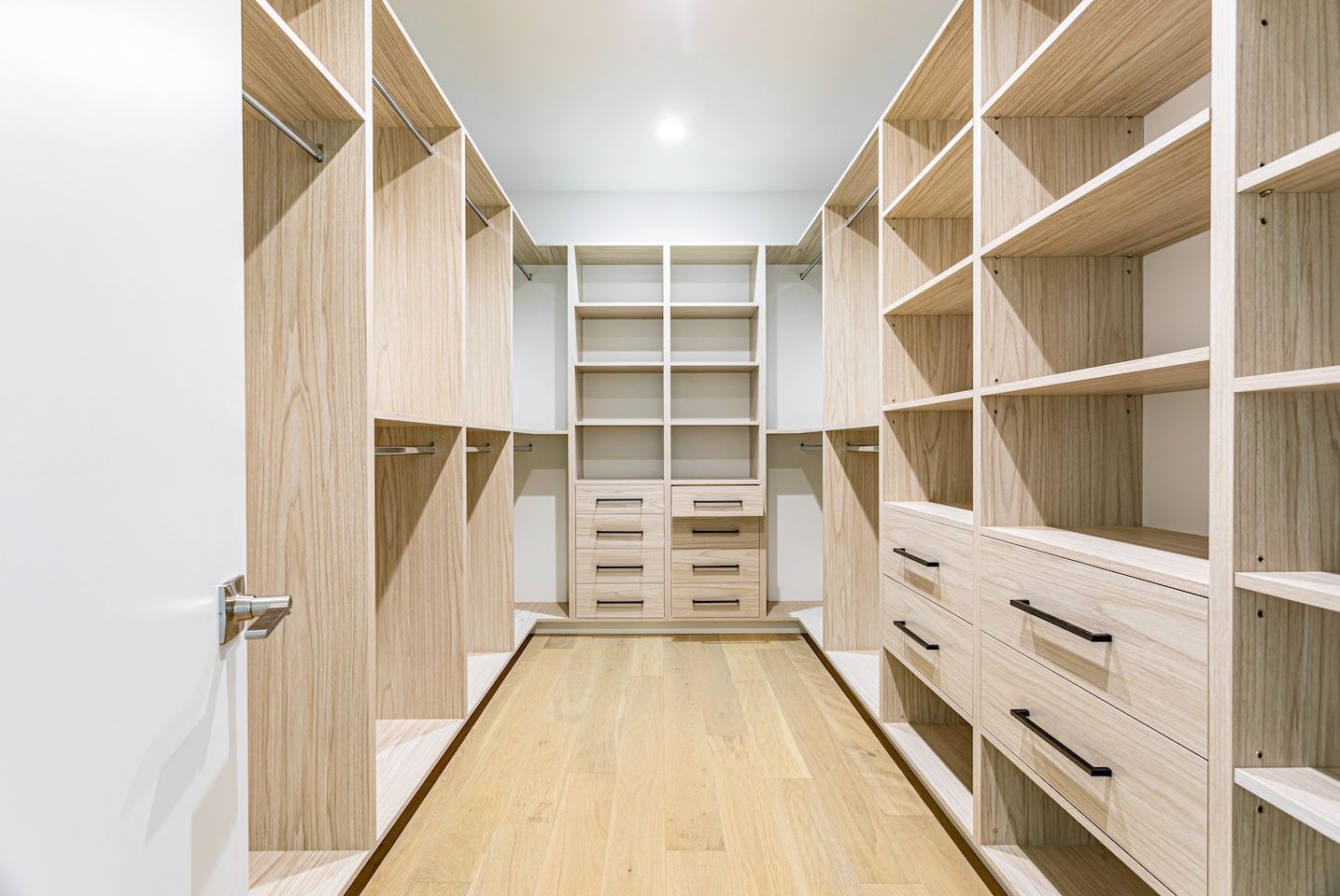 Custom built-in walk-in closet with shelves and drawers